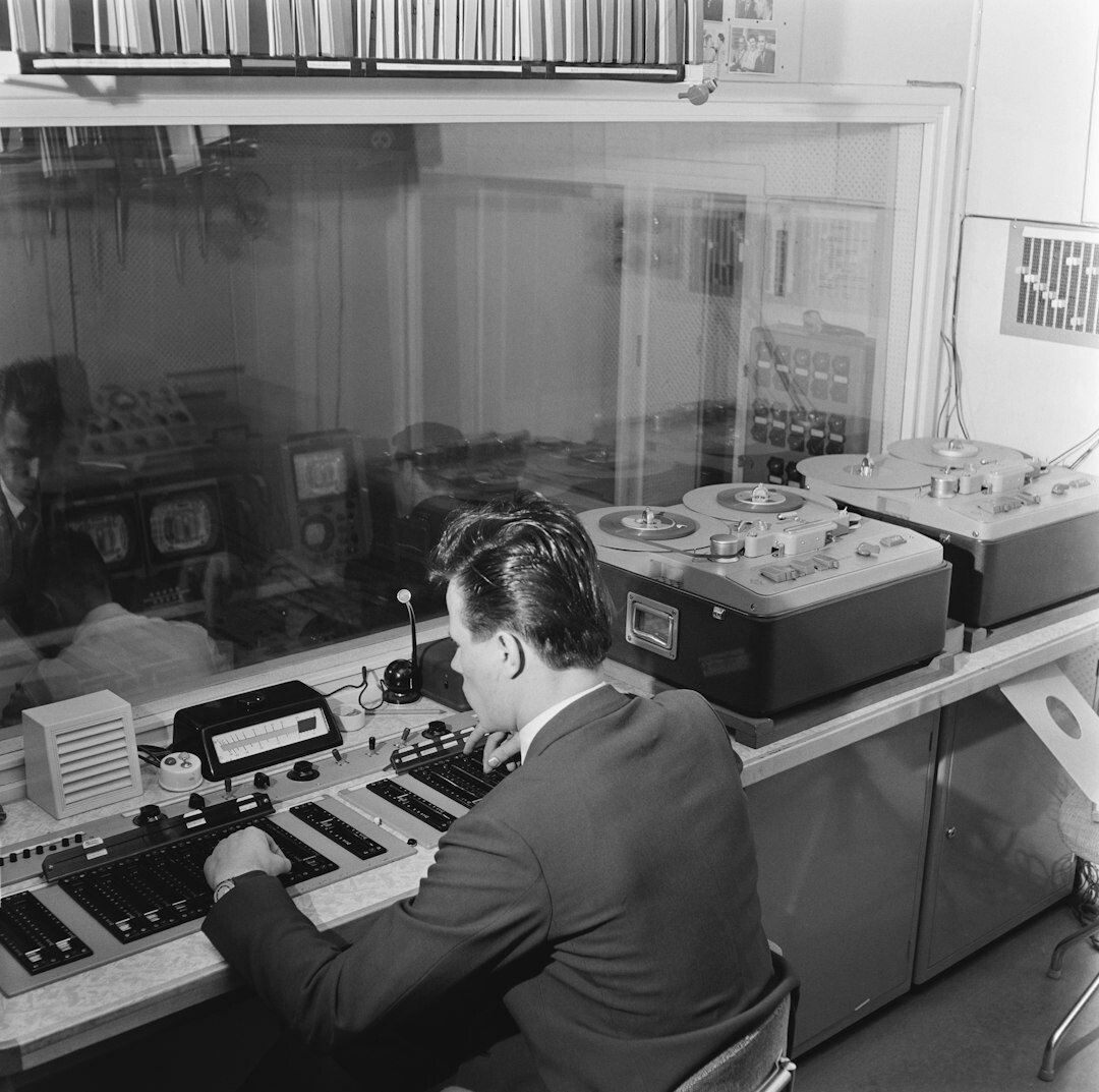 Television director giving instructions while wearing a headset in a control room