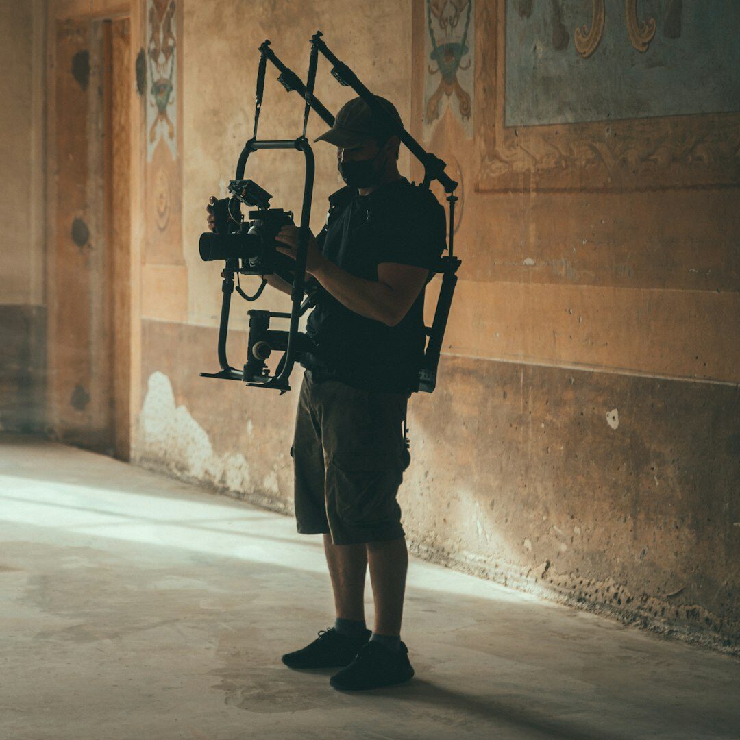 Camera operator filming with a professional broadcast camera on a studio set