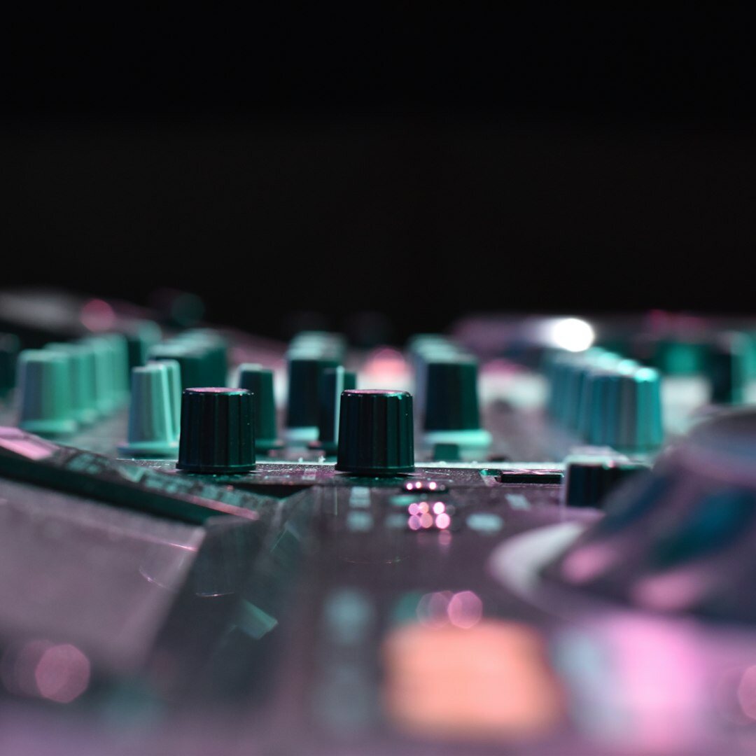 Sound engineer adjusting levels on an audio mixing console for a live broadcast