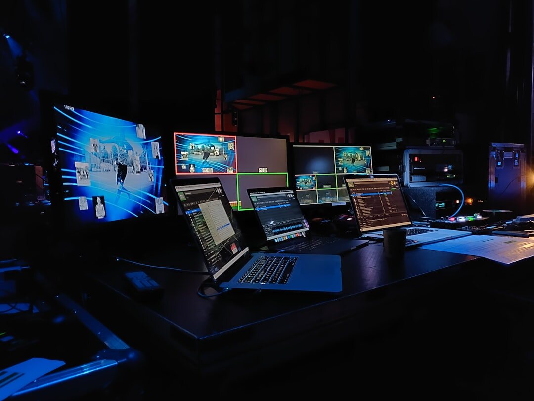 Video editing desk with multiple screens showing a broadcast timeline